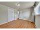 Bedroom featuring hardwood floors and closet with white doors at 7240 S Cherry Dr, Centennial, CO 80122