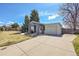 Attractive single-story home featuring a spacious driveway and a charming front yard at 7240 S Cherry Dr, Centennial, CO 80122