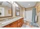 Well-lit bathroom featuring double sinks, granite countertops, and a shower-tub combination at 10233 Greatwood Ct, Highlands Ranch, CO 80126
