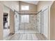 Modern bathroom featuring a glass-enclosed shower with mosaic tile and a view into a walk-in closet at 10233 Greatwood Ct, Highlands Ranch, CO 80126