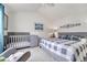 Bright bedroom with a vaulted ceiling, ceiling fan, a crib and gray color palette at 10233 Greatwood Ct, Highlands Ranch, CO 80126