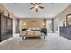Large bedroom with carpet, dual nightstands, artwork, and natural light from two windows and a door at 10233 Greatwood Ct, Highlands Ranch, CO 80126
