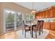 Charming dining area with hardwood floors, a table for six, and access to the outdoor deck through sliding doors at 10233 Greatwood Ct, Highlands Ranch, CO 80126