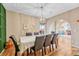 Stylish dining area features a chandelier and an arched entryway to the living room and other living areas at 10233 Greatwood Ct, Highlands Ranch, CO 80126