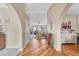 Spacious foyer features gleaming hardwood floors, archways, and views of the living room with a large window at 10233 Greatwood Ct, Highlands Ranch, CO 80126