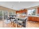 Spacious kitchen features a large island with bar seating, abundant cabinetry, hardwood floors, and natural light at 10233 Greatwood Ct, Highlands Ranch, CO 80126