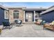 Welcoming front porch features a cozy seating area with comfortable chairs, an outdoor rug, and stylish decorations at 10233 Greatwood Ct, Highlands Ranch, CO 80126