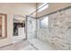 Stunning glass shower with marble tile, mosaic floor, and transom window for natural light at 10233 Greatwood Ct, Highlands Ranch, CO 80126