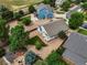 Aerial view of a landscaped yard with decorative rock, grass, mature trees, and a fenced backyard at 386 Monte Vista St, Brighton, CO 80601