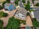 Aerial view of home with beautiful landscaping and a fenced backyard in a quiet neighborhood at 386 Monte Vista St, Brighton, CO 80601
