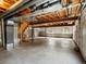 Unfinished basement with concrete floor and exposed ducts and supports at 386 Monte Vista St, Brighton, CO 80601