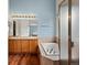 This bathroom includes a bathtub, shower, dual sinks, and updated fixtures at 386 Monte Vista St, Brighton, CO 80601