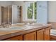 This bathroom features dual sinks with chrome fixtures and a sunny window at 386 Monte Vista St, Brighton, CO 80601