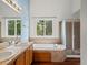 This bathroom features a large window, dual sinks, shower, and large tub at 386 Monte Vista St, Brighton, CO 80601