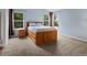 Spacious bedroom featuring carpeted floors, multiple windows, and a rustic wooden bed frame at 386 Monte Vista St, Brighton, CO 80601