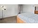 This bedroom has neutral carpet, light colored walls, and a bright sunny window at 386 Monte Vista St, Brighton, CO 80601
