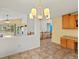 Open concept dining room with chandelier lighting and a view into the living room at 386 Monte Vista St, Brighton, CO 80601