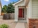 Charming single-Gathering home features a red front door, rock garden and brick accents at 386 Monte Vista St, Brighton, CO 80601