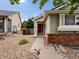 Charming single-Gathering home features a red front door, rock garden and brick accents at 386 Monte Vista St, Brighton, CO 80601