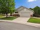 Charming home with a well-manicured lawn, mature tree, and a two-car garage at 386 Monte Vista St, Brighton, CO 80601