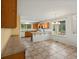 Open kitchen with wooden cabinets, tile floor, an eat-in bar and a window view at 386 Monte Vista St, Brighton, CO 80601