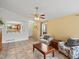 Bright living room with tile flooring and a view into the kitchen at 386 Monte Vista St, Brighton, CO 80601