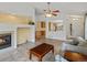 Bright living room with a fireplace, tile flooring and a view into the kitchen at 386 Monte Vista St, Brighton, CO 80601