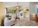 Bright living room with vaulted ceiling, a fireplace, tile flooring and a view of trees at 386 Monte Vista St, Brighton, CO 80601