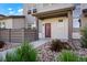 The covered porch is perfect to enjoy the beautifully landscaped walkway leading to the front door at 19029 E 64Th Pl, Denver, CO 80249