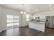 Modern kitchen with stainless steel appliances and an island at 15963 Syracuse St, Thornton, CO 80602