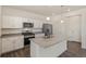 Modern kitchen with island and stainless steel appliances at 15963 Syracuse St, Thornton, CO 80602