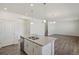 Open concept kitchen with island, stainless steel appliances, and hardwood floors at 15963 Syracuse St, Thornton, CO 80602