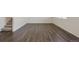 Living room with dark gray vinyl plank flooring and a staircase at 15963 Syracuse St, Thornton, CO 80602