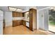 Functional kitchen with wood cabinets, laminate countertops, and a window over the sink at 8204 S Cody St, Littleton, CO 80128