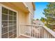 Enjoy a green view on the balcony with white railings, and a wooden floor with a sliding glass door at 4038 S Richfield Way, Aurora, CO 80013