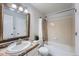 Clean bathroom showcasing a bathtub-shower combo, framed mirror, granite countertop, and bright lighting at 4038 S Richfield Way, Aurora, CO 80013