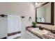 Bathroom featuring a vanity with a granite countertop and a dark wood framed mirror at 4038 S Richfield Way, Aurora, CO 80013