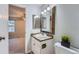 Cozy bathroom featuring a framed mirror, granite countertop, toilet, and stylish lighting fixtures at 4038 S Richfield Way, Aurora, CO 80013