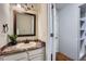 Bathroom featuring a vanity with a granite countertop and a dark wood framed mirror at 4038 S Richfield Way, Aurora, CO 80013