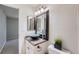 Stylish bathroom featuring a bowl sink, granite countertop, framed mirror and modern lighting fixtures at 4038 S Richfield Way, Aurora, CO 80013