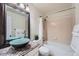 Bathroom featuring an elegant vanity with a vessel sink, a mirror and a bathtub with shower at 4038 S Richfield Way, Aurora, CO 80013