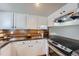 Bright kitchen featuring a modern range, stainless steel appliances, and dark countertops, creating a stylish cooking space at 4038 S Richfield Way, Aurora, CO 80013