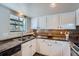 Functional kitchen featuring a double sink, plenty of upper and lower cabinet space, and modern finishes for convenient cooking at 4038 S Richfield Way, Aurora, CO 80013