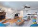 Inviting living room featuring a brick fireplace, hardwood floors, and open access to the kitchen at 4038 S Richfield Way, Aurora, CO 80013