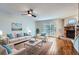 Bright living room with hardwood floors, fireplace, and sliding glass doors to the backyard at 4038 S Richfield Way, Aurora, CO 80013