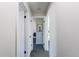 Hallway with gray carpet and white walls, doors, and trim, and a picture of a rabbit on the back wall at 7444 W 81St Ave, Arvada, CO 80003