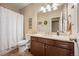 Bathroom featuring a dark wood vanity, ample countertop space, and a shower with a patterned curtain at 18067 E Anthem Dr, Parker, CO 80134