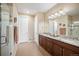 Bathroom features a double sink vanity with granite countertops and a glass-enclosed shower at 18067 E Anthem Dr, Parker, CO 80134