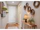 Inviting entryway with wood floors, accent wall decor and view of the living space at 18067 E Anthem Dr, Parker, CO 80134