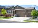 Charming single Gathering home with a large driveway and well-manicured lawn at 18067 E Anthem Dr, Parker, CO 80134